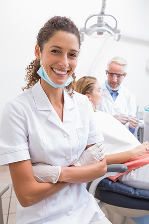 Dental assistant smiling at camera dentists with Carpal Tunnel