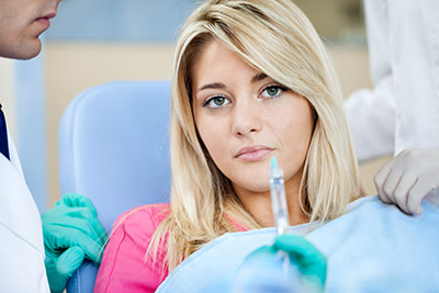 scared patient looking at injection Corticosteroid Injections for carpal tunnel