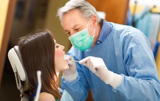 dentist working on a patient again after curing carpal tunnel