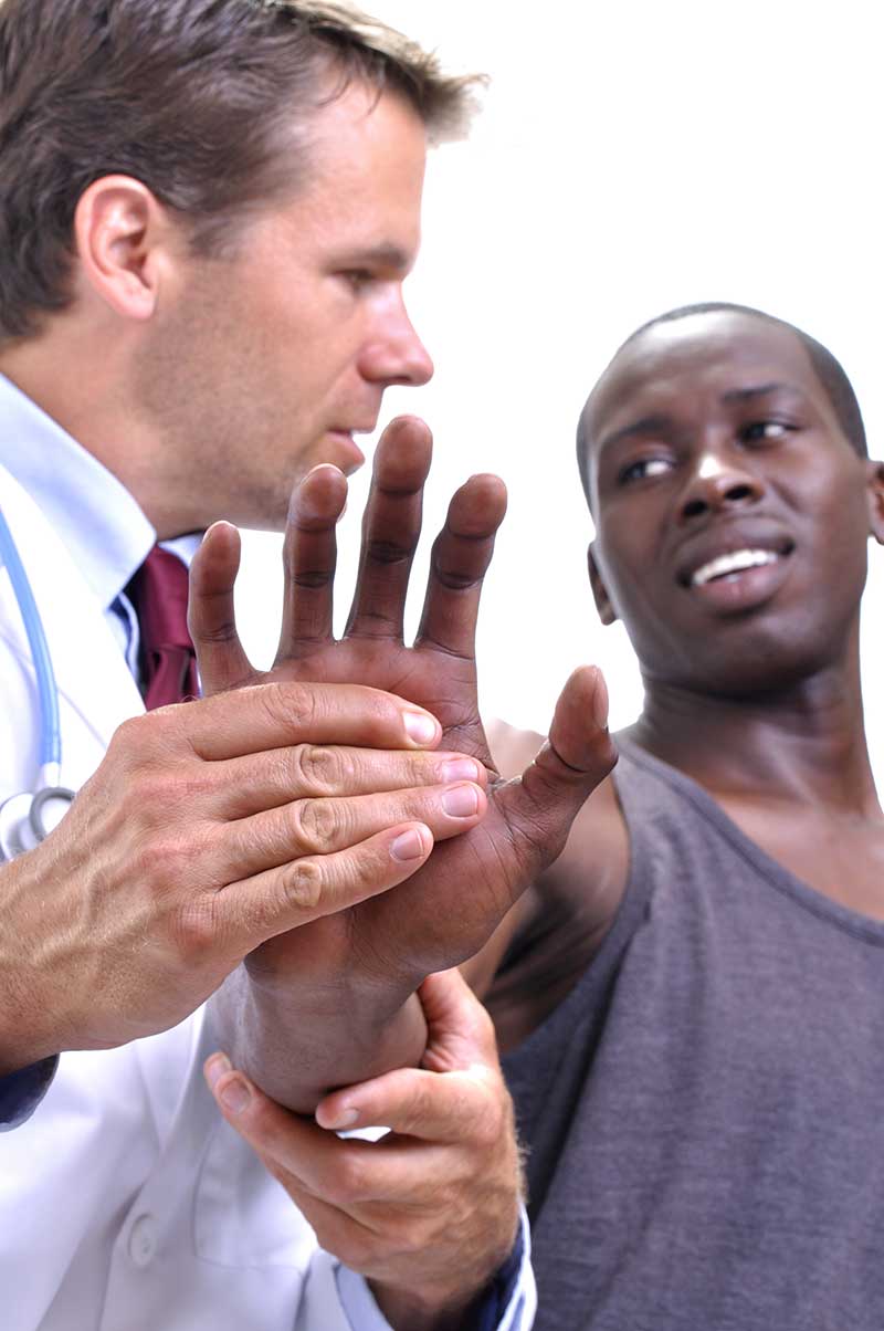 Doctor-working-on-man-with-hand-pain doctor working on man with hand pain