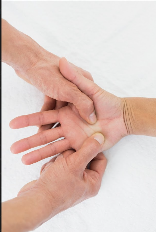 Carpal Tunnel Relief 3 Hands applying pressure to the palm during a hand therapy treatment. carpal tunnel relief