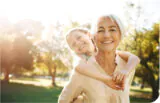 Person giving a child a piggyback ride