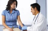 Image of a Doctor examining the hand/arm of woman for carpal tunnel syndrome. Inflammation and swelling are the root of Carpal Tunnel Syndrome