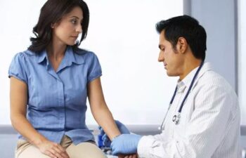 Image of a Doctor examining the hand/arm of woman for carpal tunnel syndrome. Inflammation and swelling are the root of Carpal Tunnel Syndrome