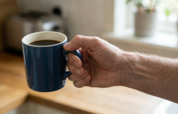 Hand resting on bed sheets during nighttime numbness and tingling linked to carpal tunnel syndrome