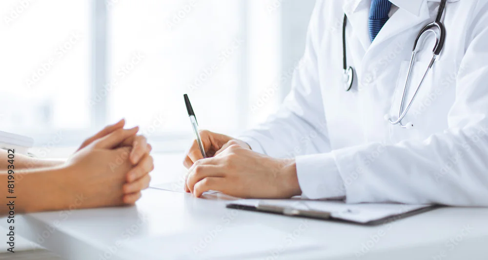 Doctor reviewing symptoms with a patient to decide on a cortisone injection for carpal tunnel